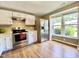 Bright kitchen features stainless steel appliances, white cabinets and a large window at 4324 Halliwell Dr, Raleigh, NC 27606