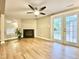 Basement living room featuring a fireplace, a ceiling fan, and outdoor access at 4324 Halliwell Dr, Raleigh, NC 27606
