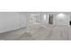 Spacious finished basement featuring painted support columns, a door to the exterior, and a spiral staircase at 437 Woodsdale Rd, Roxboro, NC 27573