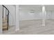 Finished basement featuring gray flooring, modern decor, spiral staircase, and white support columns at 437 Woodsdale Rd, Roxboro, NC 27573