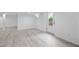 Bright basement space with light wood flooring, a glass door, and neutral paint at 437 Woodsdale Rd, Roxboro, NC 27573