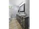 Basement bathroom features double vanity, modern mirror, and neutral decor with light gray walls at 437 Woodsdale Rd, Roxboro, NC 27573