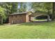 Two-story brick home with a well-manicured lawn, brick patio, and carport providing convenient parking at 437 Woodsdale Rd, Roxboro, NC 27573