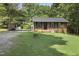 Charming brick home with a well-maintained lawn, carport and an outbuilding for extra storage at 437 Woodsdale Rd, Roxboro, NC 27573