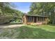 Charming brick home with a well-maintained lawn, carport and an outbuilding for extra storage at 437 Woodsdale Rd, Roxboro, NC 27573
