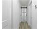 Hallway with white trim, doors, and gray vinyl flooring at 437 Woodsdale Rd, Roxboro, NC 27573