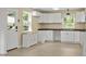 Cozy kitchen with white cabinets, wood countertop and gray vinyl flooring at 437 Woodsdale Rd, Roxboro, NC 27573