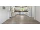 Bright kitchen with gray vinyl floors, white cabinets and a window over the sink at 437 Woodsdale Rd, Roxboro, NC 27573