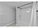 Neutral bathroom with a shower and curtain, tiled walls, and modern plumbing fixtures at 437 Woodsdale Rd, Roxboro, NC 27573