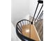 Close-up of a spiral staircase with wood steps and a black metal railing and white trim at 437 Woodsdale Rd, Roxboro, NC 27573
