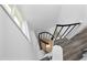 An eye-level view of a spiral staircase featuring a black metal rail and white trim at 437 Woodsdale Rd, Roxboro, NC 27573