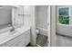 Clean bathroom with a white vanity, ample lighting, and a shower/tub combo at 448 Chinaberry Ln, Angier, NC 27501