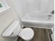 Bathroom features a bathtub and shower combo with a water-efficient toilet at 448 Chinaberry Ln, Angier, NC 27501