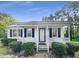 Charming single story home with covered front porch, tidy landscaping, and white exterior at 448 Chinaberry Ln, Angier, NC 27501