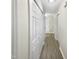 Hallway with ample storage space with the hall closets and durable wood floors at 448 Chinaberry Ln, Angier, NC 27501