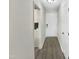 Interior hallway with sleek flooring, neutral paint, and access to kitchen and rooms at 448 Chinaberry Ln, Angier, NC 27501