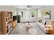 Bright living room with neutral decor, modern furniture and fixtures, and ample natural light at 448 Chinaberry Ln, Angier, NC 27501