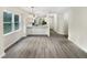 Bright living room that opens to the kitchen, complete with gray wood flooring at 448 Chinaberry Ln, Angier, NC 27501