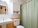 Cozy bathroom with wallpaper, a vintage-style vanity, and a shower-tub combination at 45 Softwood Dr, Franklinton, NC 27525
