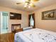 Bedroom with hardwood floors features a wall-mounted tv, a small table, and access to an adjoining bathroom at 45 Softwood Dr, Franklinton, NC 27525