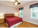 Comfortable bedroom featuring hardwood floors, a ceiling fan, and bright natural light from the windows at 45 Softwood Dr, Franklinton, NC 27525
