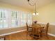 Sunny dining area featuring hardwood floors and multiple windows with plantation shutters at 45 Softwood Dr, Franklinton, NC 27525