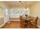Bright dining room with hardwood floors, decorative lighting, and a door to the outside at 45 Softwood Dr, Franklinton, NC 27525