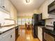 Efficient kitchen that opens to the dining area, features granite counters and neutral cabinetry at 45 Softwood Dr, Franklinton, NC 27525