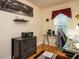 Bright home office with a glass desk, modern furnishings, and a serene view out of the window at 45 Softwood Dr, Franklinton, NC 27525