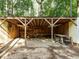 Exterior view of an open-sided woodshed with a framed structure, providing ample space for storing wood at 45 Softwood Dr, Franklinton, NC 27525