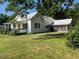 Quaint two-story home with a metal roof and a screened-in porch at 462 Ashland Dr, Goldston, NC 27252