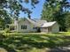 Exterior of white siding home with metal roof and screened porch at 462 Ashland Dr, Goldston, NC 27252