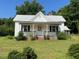 Charming single-Gathering home with a welcoming front porch and lush greenery, creating a serene and inviting curb appeal at 462 Ashland Dr, Goldston, NC 27252