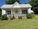 Charming two-story home with a front porch and landscaped yard at 462 Ashland Dr, Goldston, NC 27252
