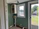 Small laundry room with open shelving and a window at 462 Ashland Dr, Goldston, NC 27252