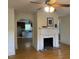 Living room showcasing a fireplace, hardwood floors, and ceiling fan at 462 Ashland Dr, Goldston, NC 27252