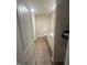 Well-lit narrow bathroom with white cabinetry, wood-look floors, and a closet at 484 Crow Field St, Roxboro, NC 27574