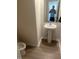 Modern half bathroom featuring a pedestal sink, wood-look floors, and neutral wall color at 484 Crow Field St, Roxboro, NC 27574