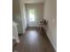 Modern entryway with light wood floors, white door with window, and a desk at 484 Crow Field St, Roxboro, NC 27574