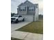 Charming two-story home with a gray exterior, front-facing garage, and a well-maintained lawn at 484 Crow Field St, Roxboro, NC 27574