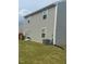 Exterior back of the home with neutral vinyl siding and well-maintained lawn at 484 Crow Field St, Roxboro, NC 27574