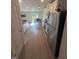 Bright kitchen with stainless steel appliances, light-colored cabinets, and hardwood floors at 484 Crow Field St, Roxboro, NC 27574