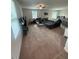 Comfortable living room featuring plush carpet, sofa, and ample natural light at 484 Crow Field St, Roxboro, NC 27574
