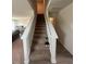 Carpeted staircase featuring white railings and wood trim, connecting multiple floors of the home at 484 Crow Field St, Roxboro, NC 27574