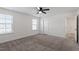 Large bedroom with carpet, two windows, ceiling fan, and two doors at 485 Hawksbill Dr, Franklinton, NC 27525