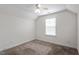 Upstairs bedroom includes carpet floors, a ceiling fan, and a sunlit window, creating a cozy retreat at 485 Hawksbill Dr, Franklinton, NC 27525