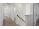 Upstairs hallway with carpet, white walls, and wood railing detail at 485 Hawksbill Dr, Franklinton, NC 27525