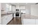Modern kitchen featuring stainless steel appliances, granite counters, and white cabinets at 485 Hawksbill Dr, Franklinton, NC 27525