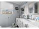 Bathroom featuring a dual vanity, decorative mirrors, and a bright window at 51 Brafford Estates Dr, Cameron, NC 28326