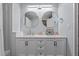 Stylish bathroom featuring a double vanity with marble countertop and unique round mirrors at 51 Brafford Estates Dr, Cameron, NC 28326